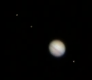 Jupiter seen through a small astronomical telescope in September 2010, together with a few of its moons. Note the disappearance of the Southern Equatorial Belt. South is upwards and towards the right (Copyright Martin J Powell, 2010)