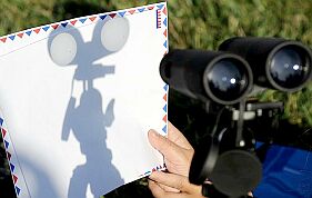 Projecting the Sun's image using a pair of binoculars (Image: Robyn Beck/AFP/Getty Images/'The Guardian' newspaper)