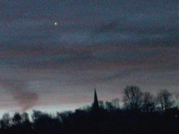 Venus seen through thin cloud at daybreak (Copyright Martin J Powell, 2004)